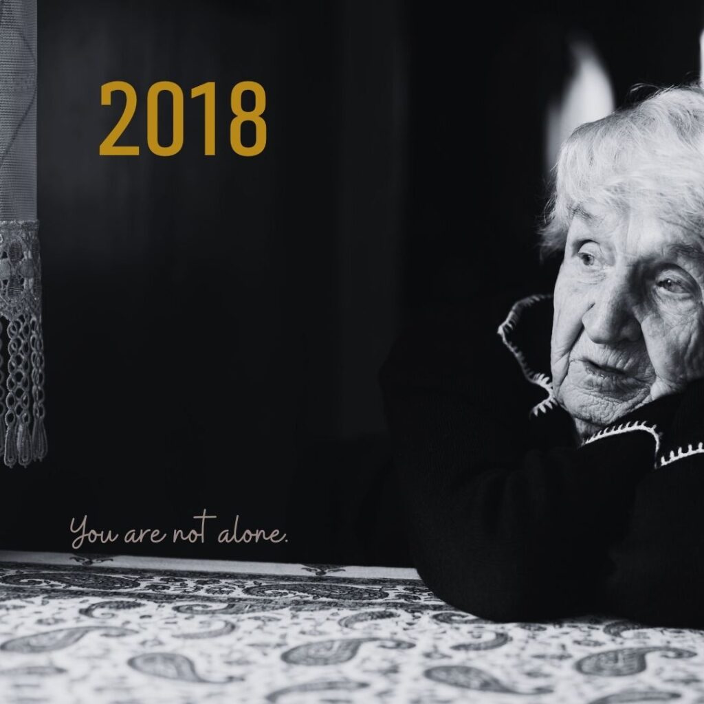 The year "2018" superimposed over a photo of an older woman with an uncertain expression