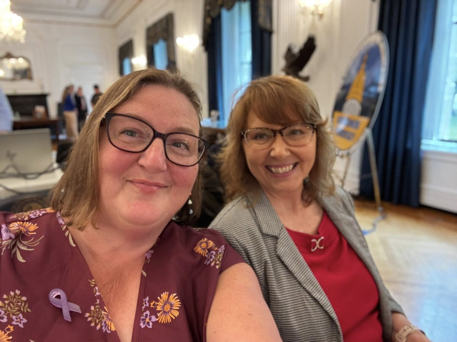 WVCADV representatives Lissa Lucas and Joyce Yedlosky smile in the gallery